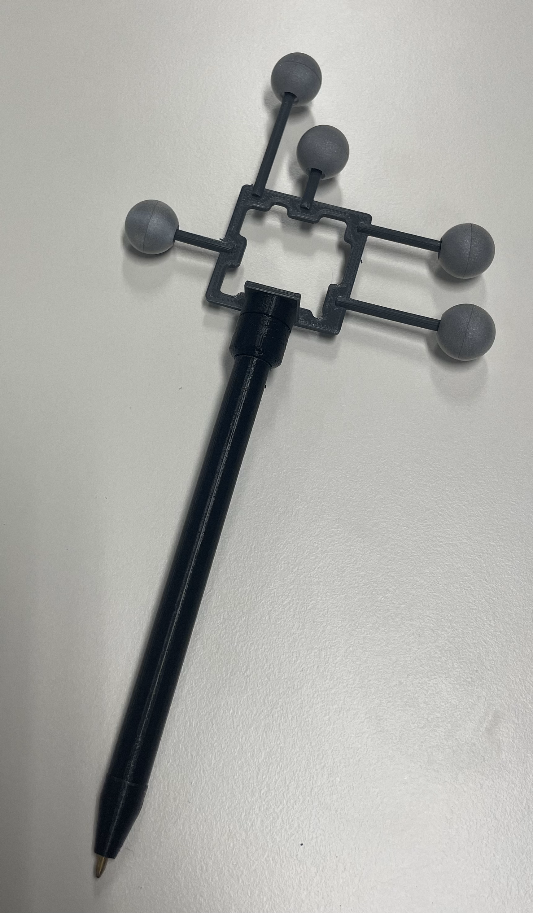 3D-printed pen with five reflective markers attached to it.